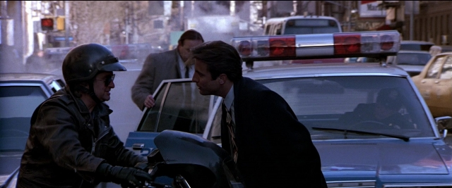Frame from Black Rain — dialogue, street, hat