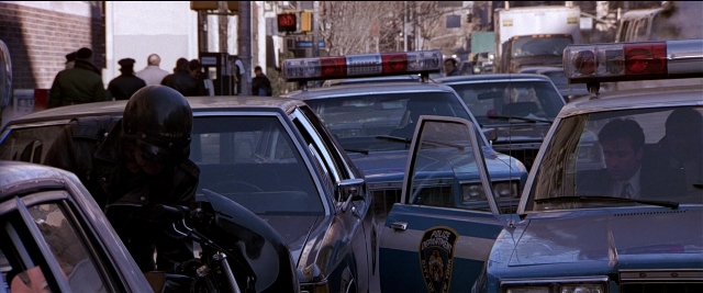 Frame from Black Rain — sitting, walking, street
