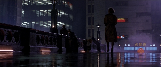 Wide shot frame from Black Rain — walking, street, night