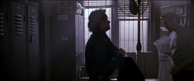 Wide shot frame from Black Rain — sitting, standing, room
