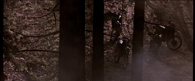 Wide shot frame from Black Rain — standing, hat, bicycle