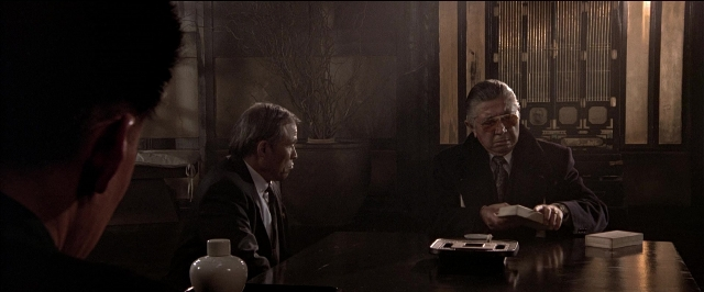 Wide shot frame from Black Rain — people, sitting, action