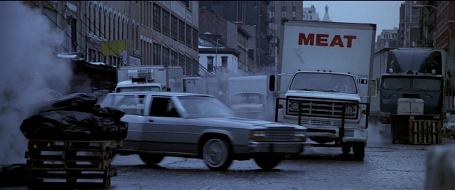 Frame from Black Rain — street, car, truck