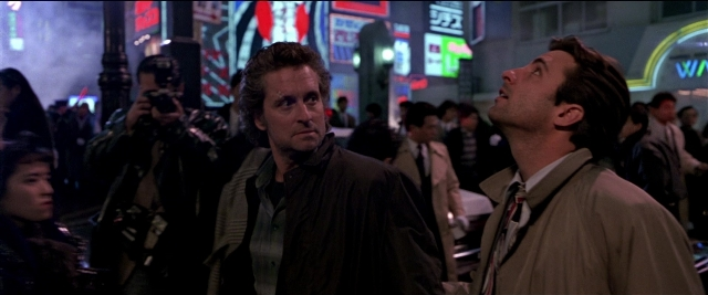Wide shot frame from Black Rain — standing, walking, street