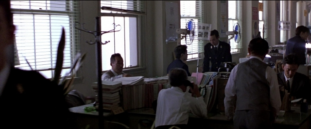 Wide shot frame from Black Rain — sitting, room, dialogue