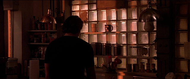 Wide shot frame from Black Rain — standing, room, kitchen