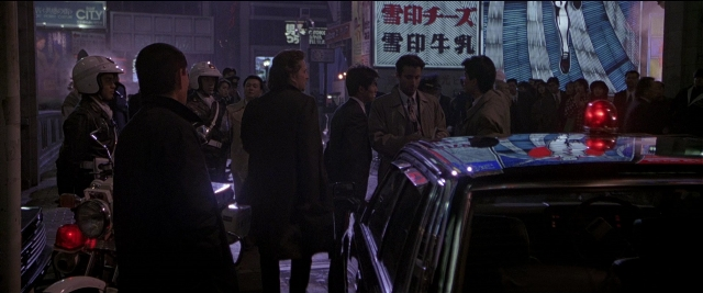 Wide shot frame from Black Rain — standing, street, car