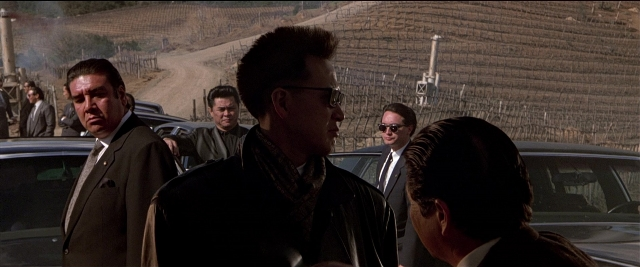 Wide shot frame from Black Rain — standing, dialogue, street