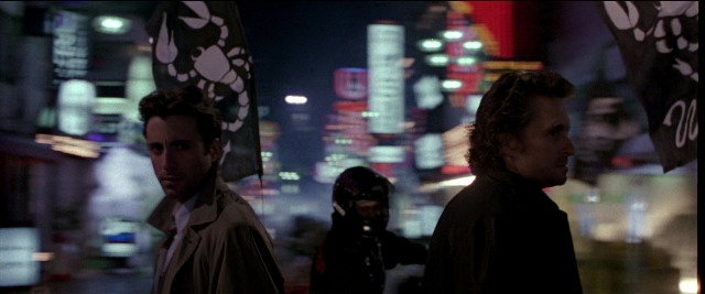 Wide shot frame from Black Rain — standing, coat, night