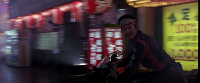 Wide shot frame from Black Rain — sitting, street, night