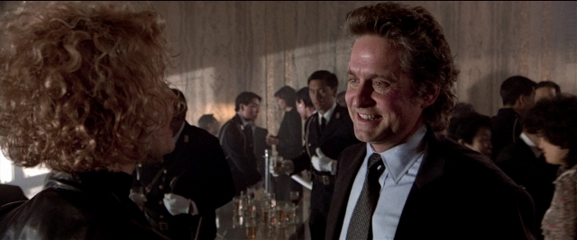 Wide shot frame from Black Rain — standing, room, table