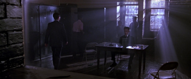 Wide shot frame from Black Rain — standing, room, table