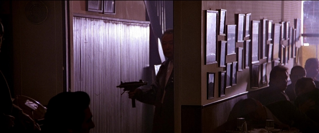 Wide shot frame from Black Rain — sitting, standing, room