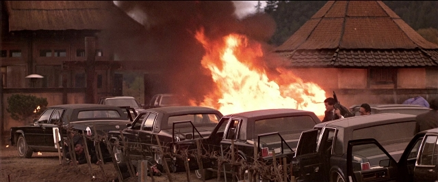 Frame from Black Rain — standing, fire, car