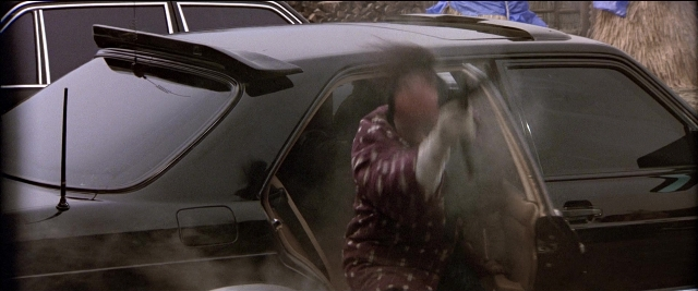 Wide shot frame from Black Rain — standing, street, car