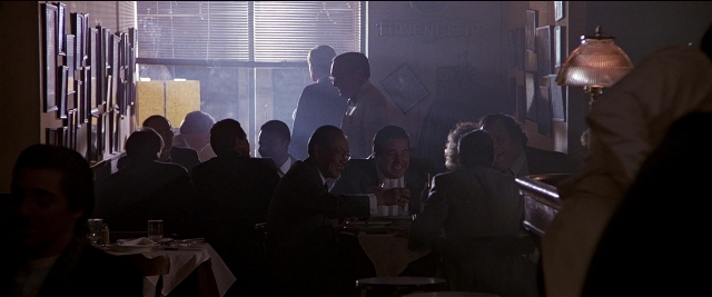 Frame from Black Rain — sitting, table, dialogue