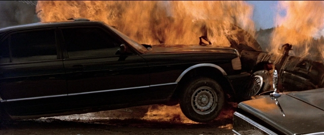 Frame from Black Rain — street, fire, car