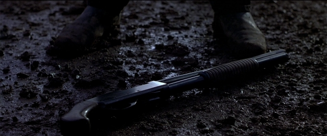 Frame from Black Rain — bed, shotgun, person