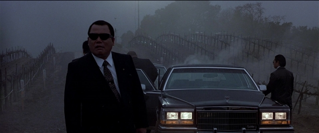 Wide shot frame from Black Rain — standing, car, suit