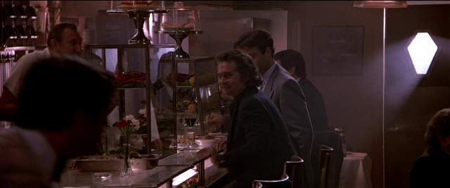 Wide shot frame from Black Rain — standing, table, kitchen