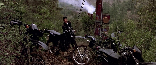 Wide shot frame from Black Rain — standing, phone, hand