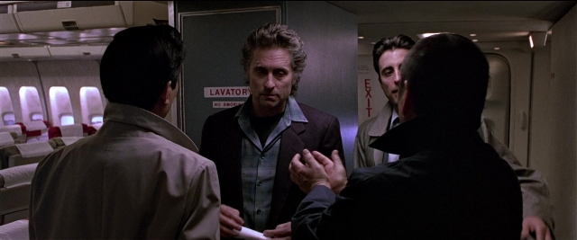 Wide shot frame from Black Rain — standing, door, suit
