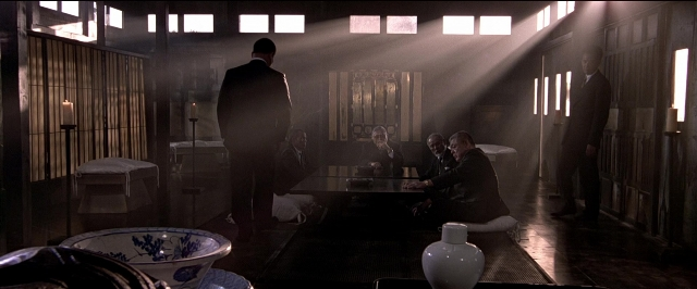 Frame from Black Rain — sitting, standing, plate