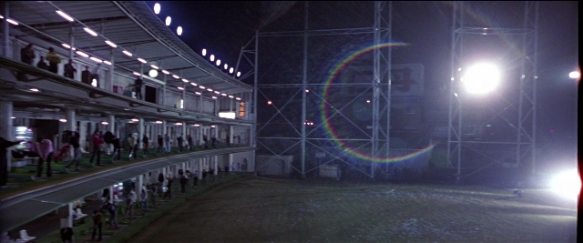 Frame from Black Rain — sitting, standing, night