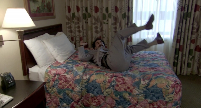 Wide shot frame from Borat: Cultural Learnings of America for Make Benefit Glorious Nation of Kazakhstan — room, bed, phone