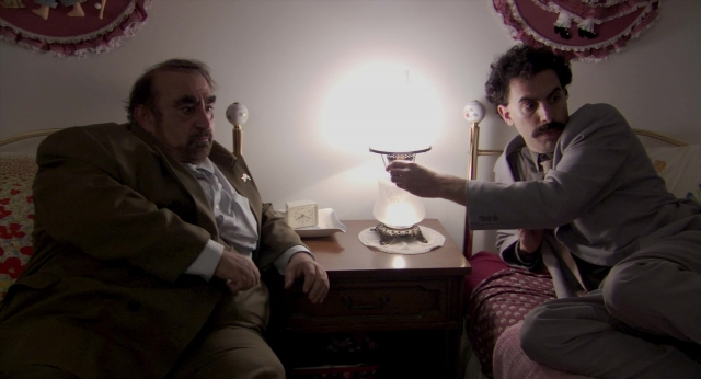 Wide shot frame from Borat: Cultural Learnings of America for Make Benefit Glorious Nation of Kazakhstan — sitting, room, table