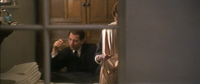 Wide shot frame from Gosford Park — sitting, standing, room