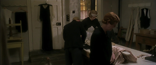Wide shot frame from Gosford Park — standing, room, bed