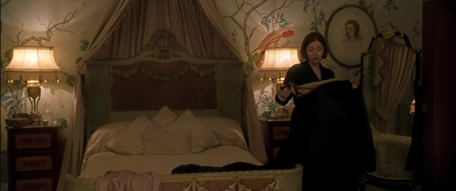 Wide shot frame from Gosford Park — book, standing, room
