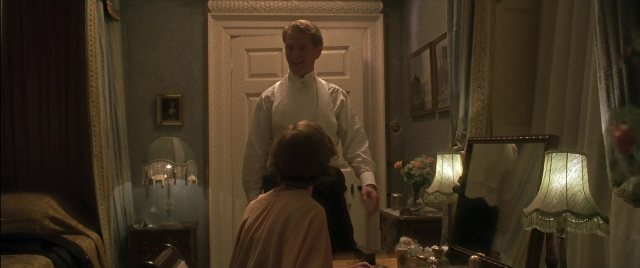 Wide shot frame from Gosford Park — sitting, standing, room