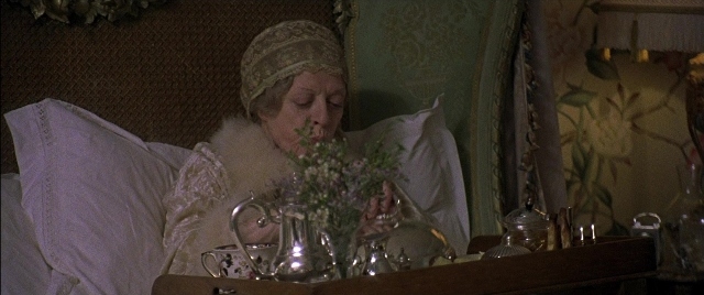 Wide shot frame from Gosford Park — sitting, room, table