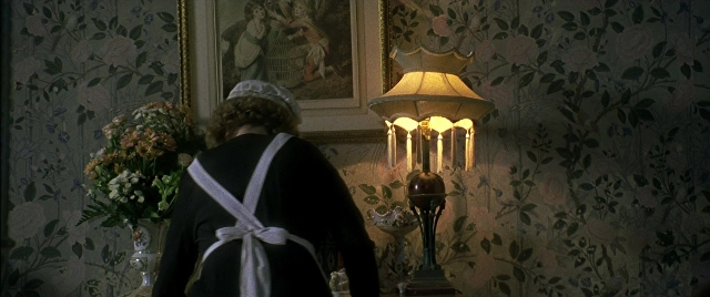 Wide shot frame from Gosford Park — standing, room, table