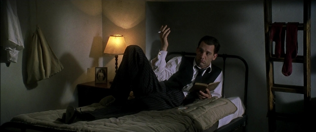 Wide shot frame from Gosford Park — sitting, book, room