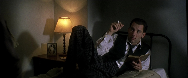 Wide shot frame from Gosford Park — sitting, book, room