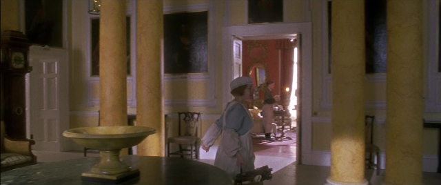 Wide shot frame from Gosford Park — standing, room, table