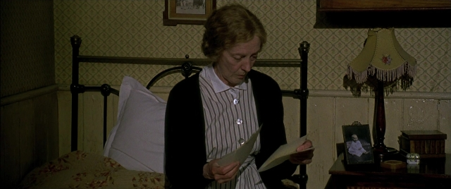 Wide shot frame from Gosford Park — sitting, bed, shirt