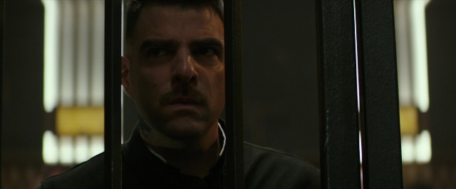 Medium shot frame from Hotel Artemis — room, mustache, face