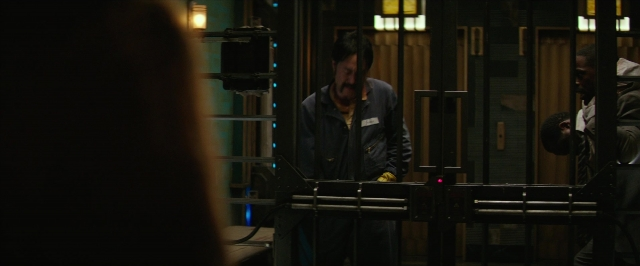 Wide shot frame from Hotel Artemis — standing, room, hat