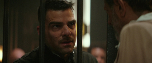 Medium shot frame from Hotel Artemis — standing, room, shirt