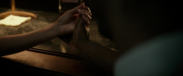 Wide shot frame from Hotel Artemis — room, person