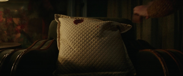 Wide shot frame from Hotel Artemis — room, hand, chair