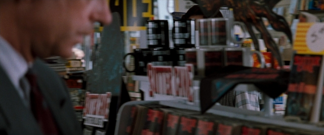 Frame from In the Mouth of Madness — standing, suit, tie