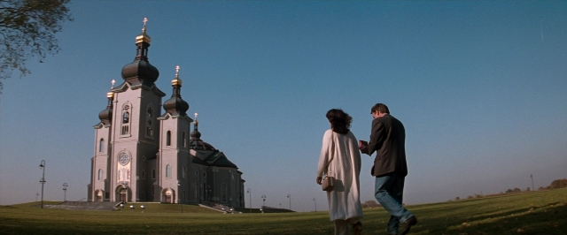 Frame from In the Mouth of Madness — walking, hand, suit