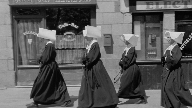 Wide shot frame from In the Mouth of Madness — people, action, show