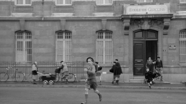 Wide shot frame from In the Mouth of Madness — people, action, show