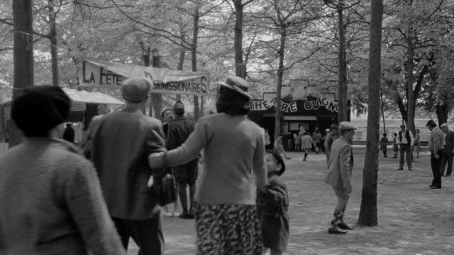 Wide shot frame from In the Mouth of Madness — people, action, show